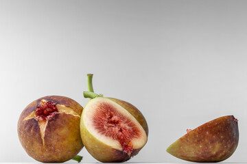 White background photo of figs cut in half.