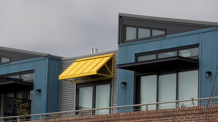 Yellow awning  over modern building  with blue walls in Cedros district