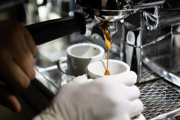 Fototapeta na wymiar Hands Of Barista Making Coffee In Bar