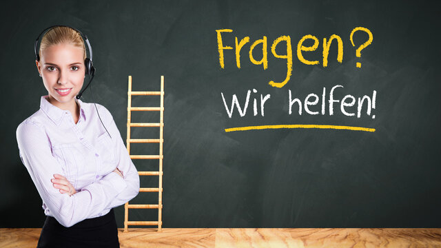 businesswoman in front of a chalkboard with the German message for QUESTIONS? WE CAN HELP!
