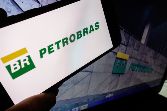 Petrobras company (Petroleo Brasileiro SA) logo visible on smartphone screen, with picture of its headquarter building on background