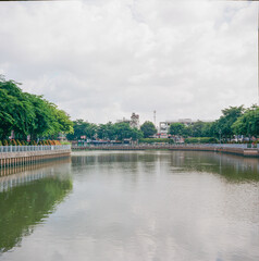Fototapeta na wymiar Time: June 27, 2021. Location: Ho Chi Minh City. Landscape photo: apartment building along Nhieu Loc - Thi Nghe canal (Vietnam)