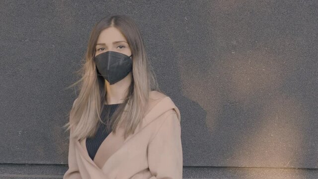 Fashionable girl wearing mask. Businesswoman portrait outdoors.