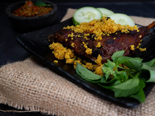 Picture of baked duck on a square black plare