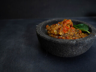 Pictures of 'sambal' an Indonesian spicy food on a stone bowl