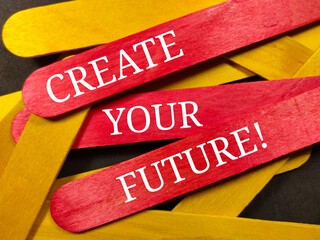 Fototapeta na wymiar Text CREATE YOUR FUTURE on colorful wooden stick with wooden stick and black background.
