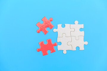 jigsaw puzzle on a blue background. Completing final task, missing jigsaw puzzle pieces and business concept with a puzzle piece missing.