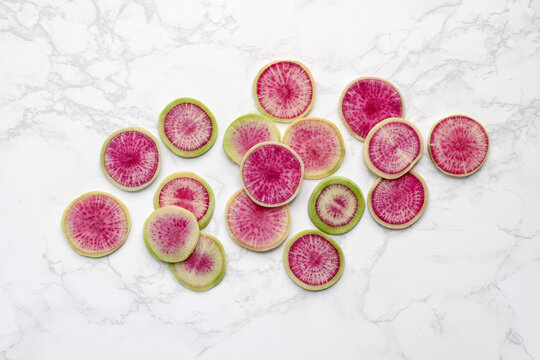 Watermelon Radish Slices on Marble Background