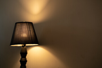 Table lamp against the wall indoor.