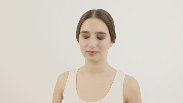 The girl performs breathing exercises to calm the body. Meditation for the body.