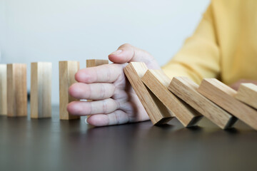 Hands of businesswomen playing wooden block game. Concept Risk of management and strategy plans for business growth and success