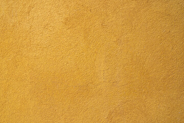 Yellowtextured concrete wall. background