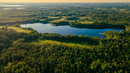 Incredibly beautiful aerial view landscape: green forest, fields, trees, lake. Wonderful sunset. Desktop wallpaper