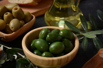 Olives, olive branch ,Olive oil on wooden background