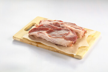 Raw pork fillet over board