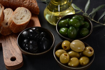 Olives, olive branch ,Olive oil on wooden background