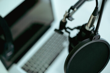 Modern wired headphone left on laptop computer with copyspace.