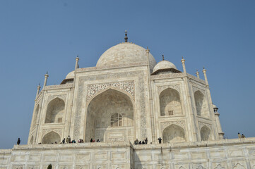 Fototapeta na wymiar The Taj Mahal, originally the Rauza-i-munawwara is an ivory-white marble mausoleum on the southern bank of the river Yamuna in the Indian city of Agra. 