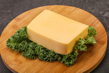Tasty yelloow Tilsiter cheese brick