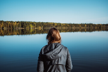 Woman on a calm lake during autumn