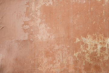 facade plaster texture in orange color, old cracked wall