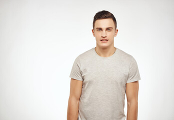 handsome man in light t-shirt cropped view studio lifestyle
