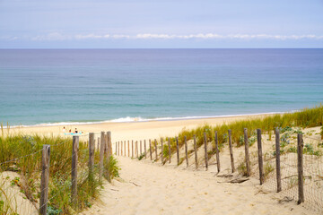 Coast access sandy patway fence to ocean beach atlantic coast at Cap-Ferret in France