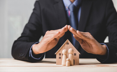 Insurance house, and family health live concept. The insurance agent presents the ้hands...