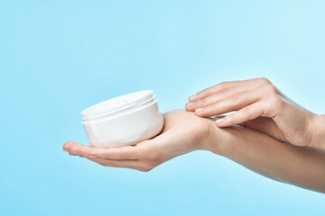 woman holding a jar of cream close-up dermatology skin care
