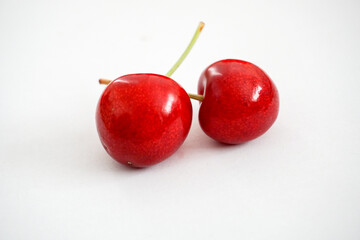 Angle view of cherries on white background