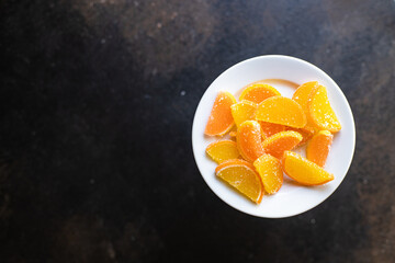 slices of marmalade jelly candy sweets candy citrus orange, tangerine, grapefruit, lemon on the table, healthy food meal snack copy space food background rustic. top view