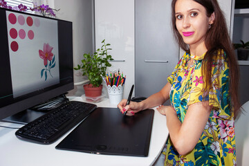 A Smiling Graphic Designer, Illustrator, Business Woman, Entrepreneur is working with computer and...
