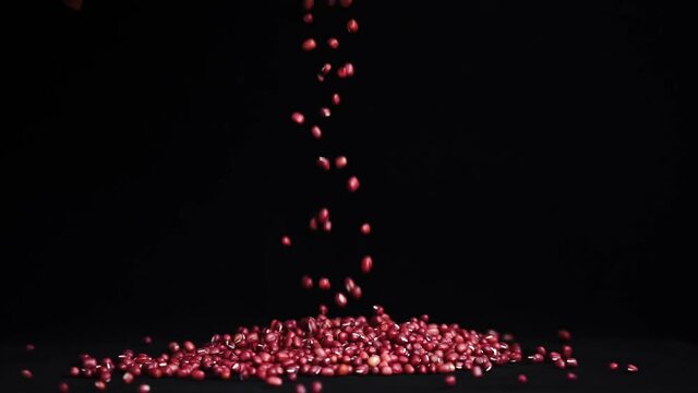 Organic red beans sprinkled on black background