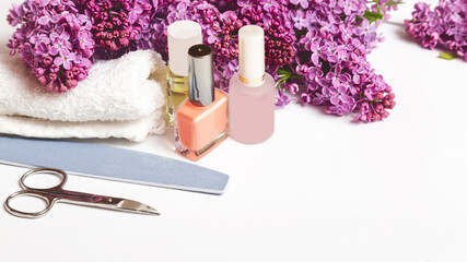 Flat lay composition with personal care products with branches of lilac on white table.background....