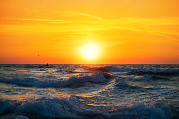 Fisherman sailing with his boat on beautiful sunrise over the sea