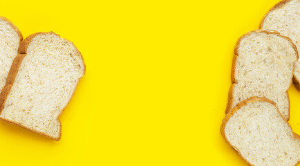 Fototapeta na wymiar Sliced wholegrain bread on yellow background.