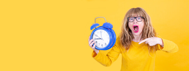 nervous and worried hysterical woman with alarm clock isolated