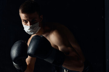 guy in medical mask and in boxing gloves on isolated background cropped view Copy Space