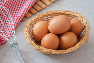 Raw chicken eggs in wicker basket