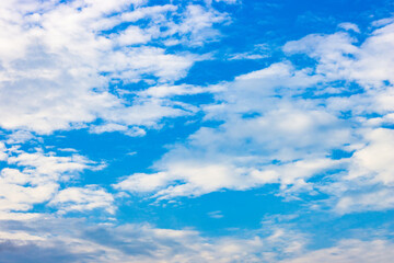 Naklejka na ściany i meble Evening blue sky with white clouds