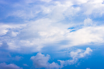 Naklejka na ściany i meble Sunny blue sky with soft white clouds