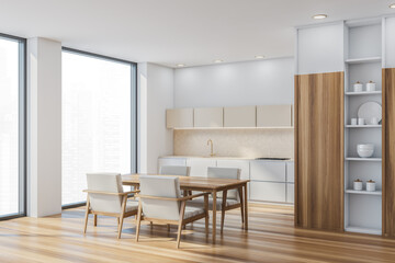 Fototapeta na wymiar Corner of beige kitchen area with table, armchairs, panoramic windows