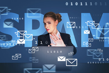 Businesswoman wearing suit is sitting at workplace looking at la