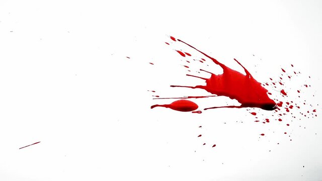 Red paint or ink splattering on white background, abstract blood splashes