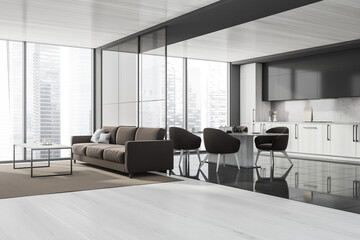 Corner of grey panoramic kitchen with brown sofa