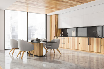 Corner of panoramic kitchen with grey chairs, wooden elements