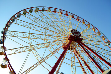 Round Ferris wheel on a background of blue sky.