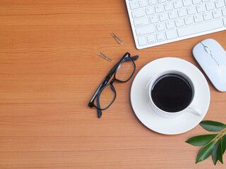 Concept work from home. Top view office desk table  with a cup of coffee, keyboard,supplies with workspace. 