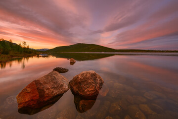 Beautiful clouds at dawn over a mountain lake
