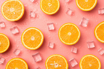 Top view photo of orange slices ice cubes and water drops on isolated light pink background